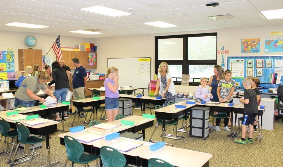 Students and parents in a classroom for open house